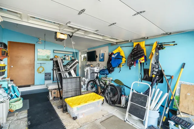 a living room with stainless steel appliances furniture and a window