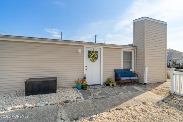 a view of a patio with a table and chairs and potted plants