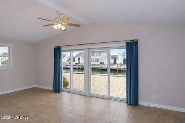 a view of a livingroom with a ceiling fan and window