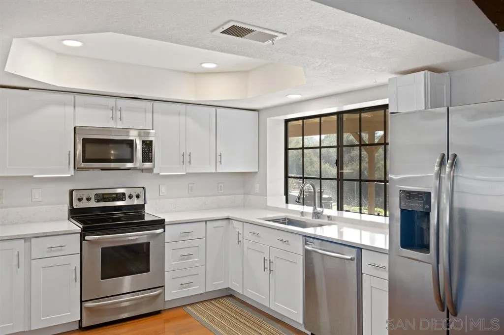 30540 Rock Stone Road Valley Center, CA 92082 - Photo 8 of 24 a kitchen with a sink stove and microwave