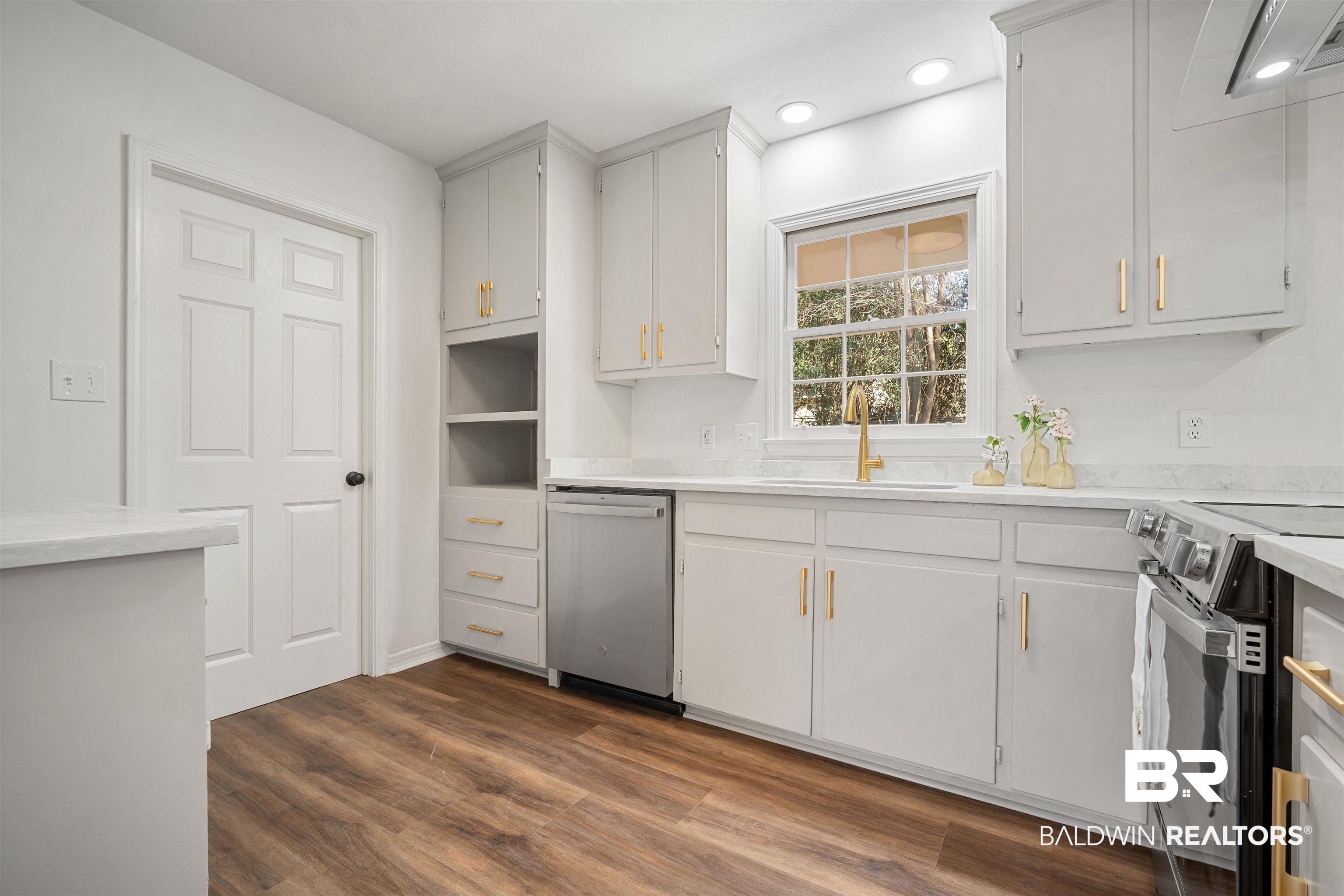 860 Montfort Road South Mobile, AL 36608 - Photo 10 of 27 Kitchen with stainless steel dishwasher, range with electric cooktop, recessed lighting, white cabinets, and dark wood-type flooring