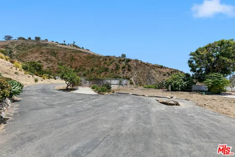 a view of a road with a building in the background