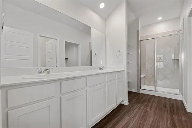 a spacious bathroom with a double vanity sink and a mirror