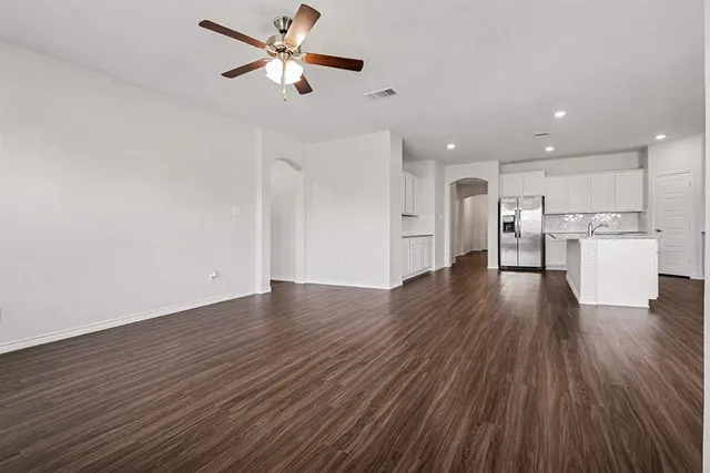 a view of a kitchen with a sink and wooden floor
