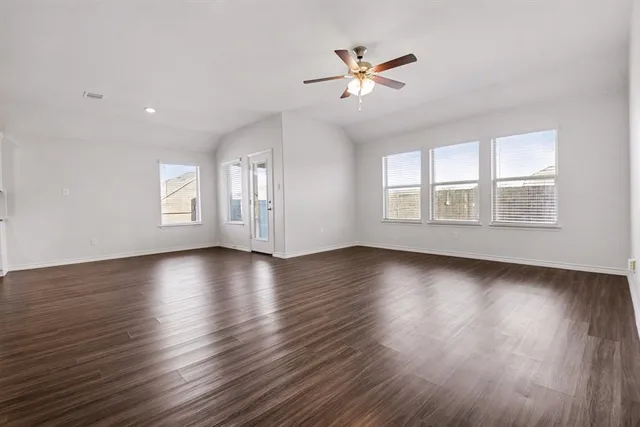 a view of a livingroom with wooden floor and window
