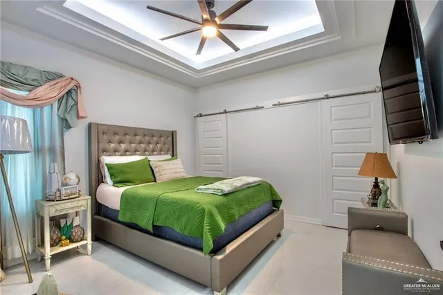 a bedroom with a bed a couch and a window