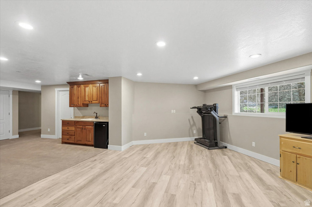 353 Robin Street Smithfield, UT 84335 - Photo 32 of 70 Exercise area with recessed lighting, light wood-style floors, and bar with sink