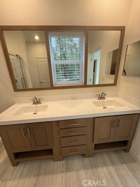 1281 Pleasant Valley Road, Unit 43 Diamond Springs, CA 95619 - Photo 12 of 14 a bathroom with a double vanity sink and a mirror