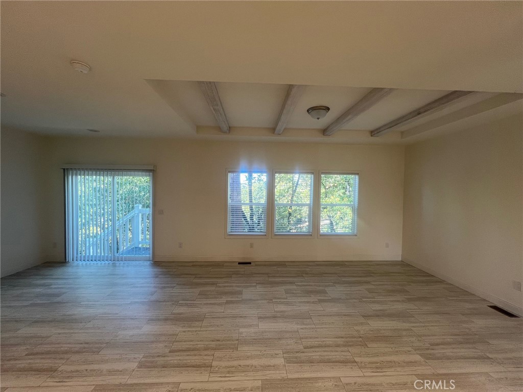1281 Pleasant Valley Road, Unit 43 Diamond Springs, CA 95619 - Photo 3 of 14 an empty room with wooden floor and windows