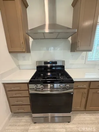 a stove top oven sitting inside of a kitchen