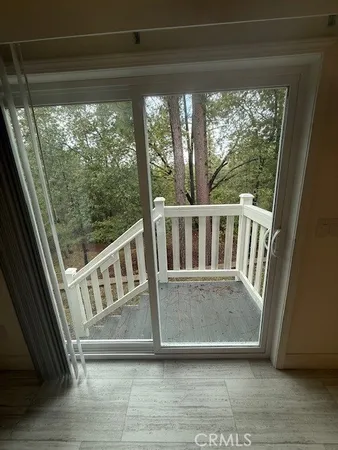 a view of a porch with a floor to ceiling window