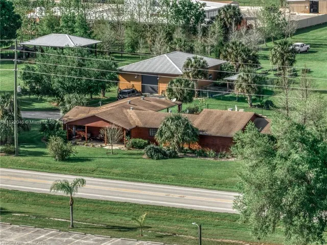 a view of a house with a yard and sitting area