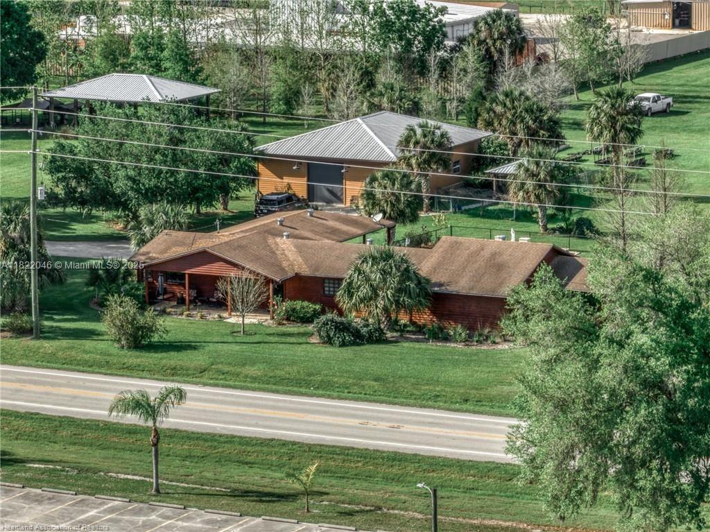 a view of a house with a yard and sitting area