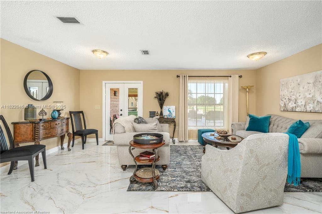 479 E Street Zolfo Springs, FL 33890 - Photo 14 of 50 a living room with furniture a table and a large window
