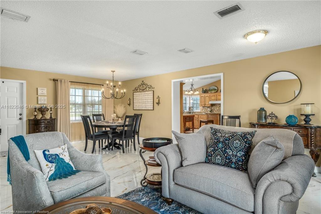 479 E Street Zolfo Springs, FL 33890 - Photo 17 of 50 a living room with furniture dining table and a large window