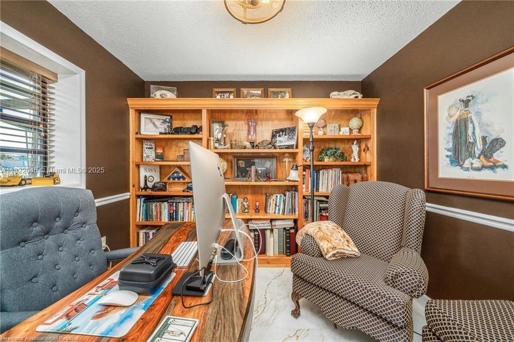 479 E Street Zolfo Springs, FL 33890 - Photo 36 of 50 a living room with furniture a bookshelf and a window