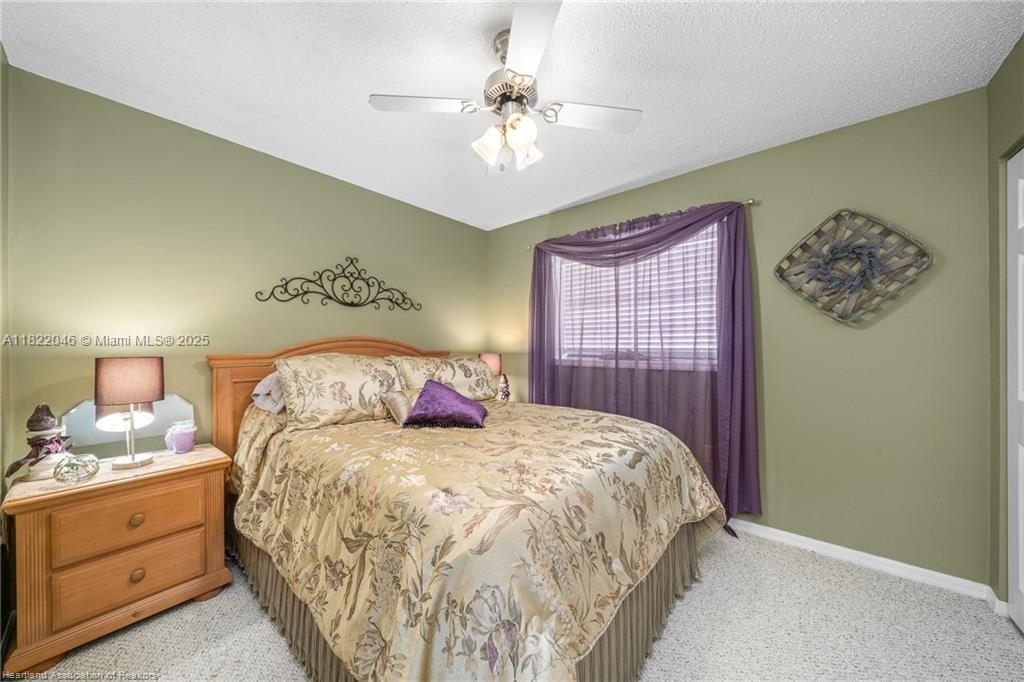 479 E Street Zolfo Springs, FL 33890 - Photo 38 of 50 a bedroom with a large bed and a chandelier