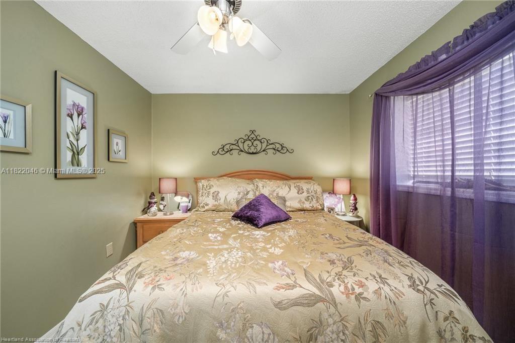 479 E Street Zolfo Springs, FL 33890 - Photo 39 of 50 a bedroom with a bed and a chandelier