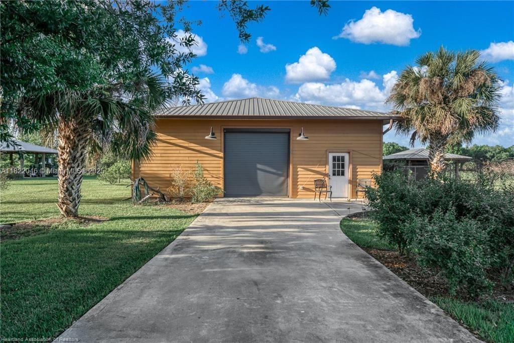 479 E Street Zolfo Springs, FL 33890 - Photo 40 of 50 a front view of a house with a yard and garage