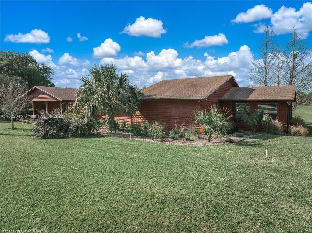 479 E Street Zolfo Springs, FL 33890 - Photo 43 of 50 a view of a house with a yard and a garden