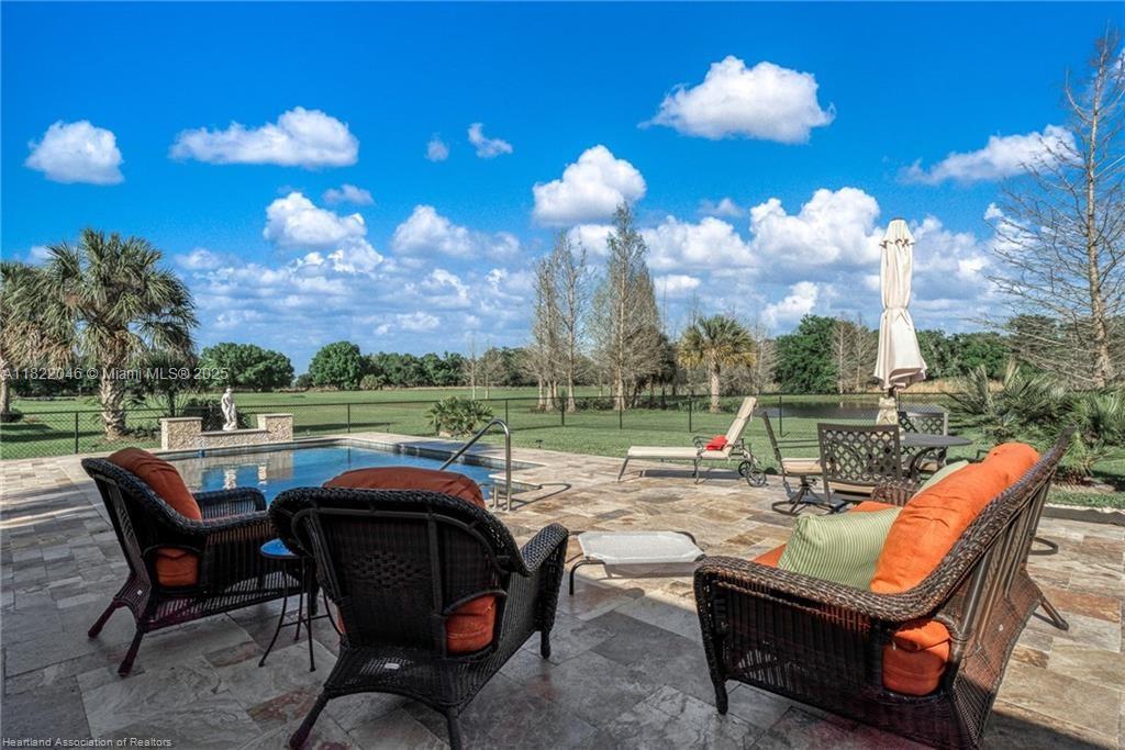 479 E Street Zolfo Springs, FL 33890 - Photo 48 of 50 a view of a patio with a dining table chairs and a fire pit