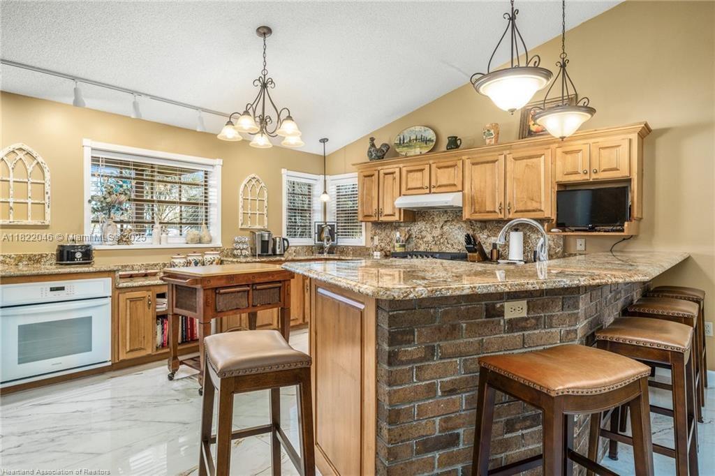 479 E Street Zolfo Springs, FL 33890 - Photo 9 of 50 a kitchen with a sink stove and microwave
