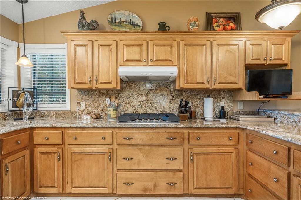 479 E Street Zolfo Springs, FL 33890 - Photo 10 of 50 a kitchen with granite countertop a sink stainless steel appliances and cabinets