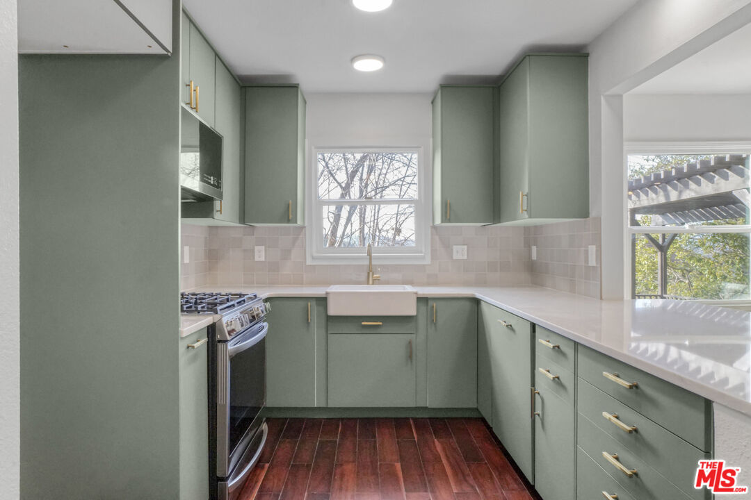 5442 Ebey Avenue Los Angeles, CA 90042 - Photo 11 of 40 a kitchen with a sink window and cabinets