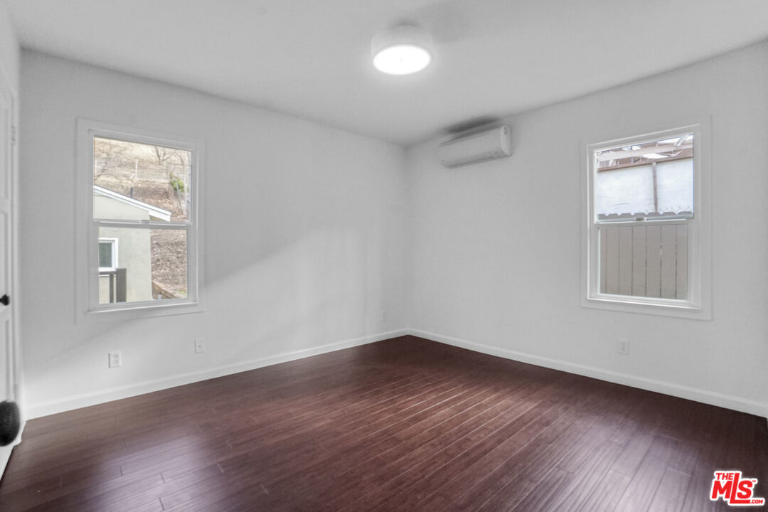 5442 Ebey Avenue Los Angeles, CA 90042 - Photo 16 of 40 a view of a room that has wooden floor and windows in it