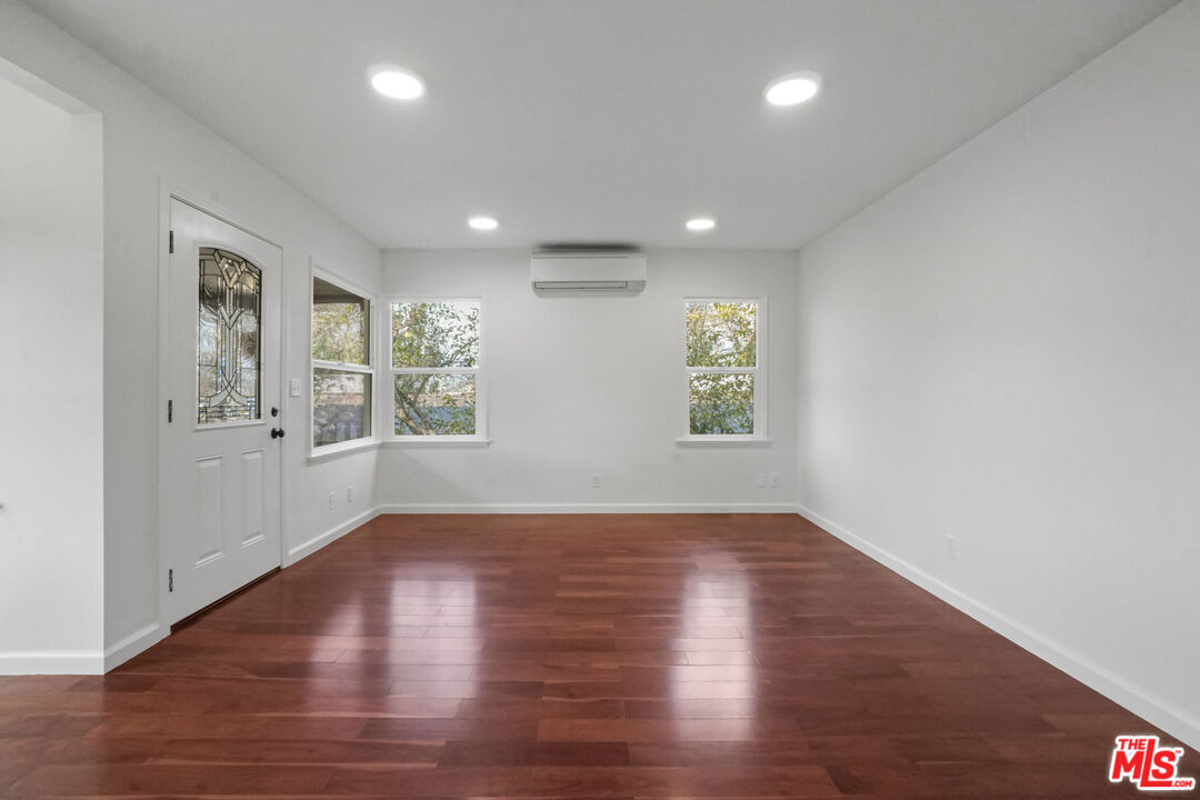 5442 Ebey Avenue Los Angeles, CA 90042 - Photo 8 of 40 an empty room with wooden floor and windows