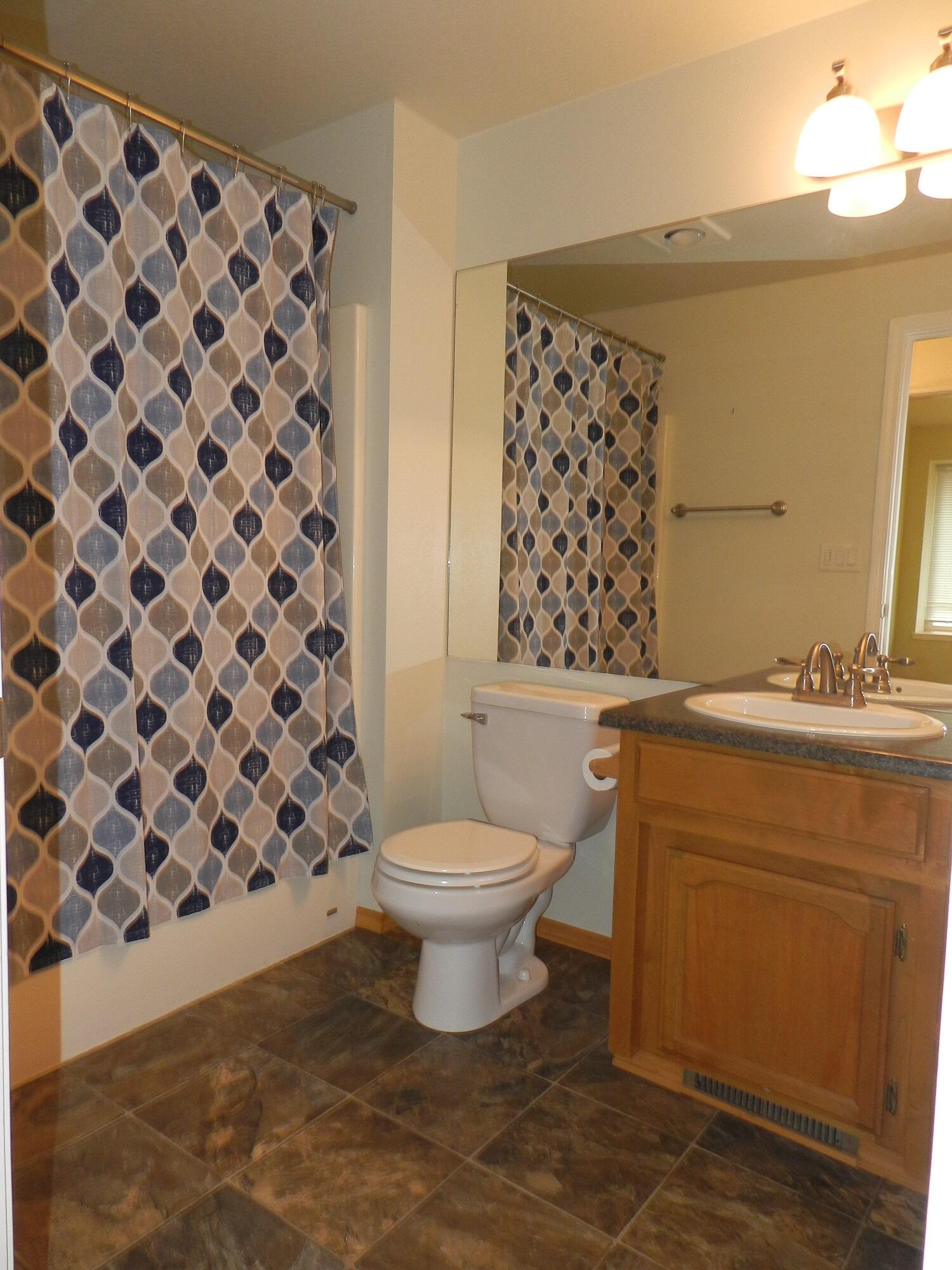 648 Benjamin Way Phoenix, OR 97535 - Photo 19 of 29 a bathroom with a granite countertop toilet a sink and a mirror