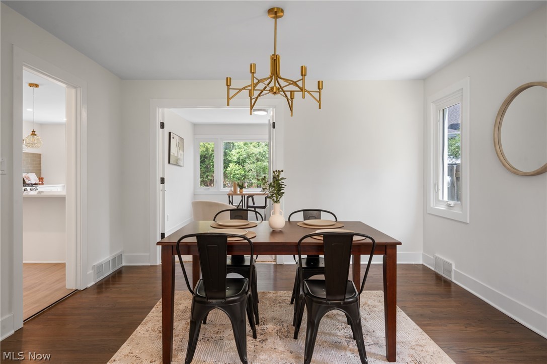 22625 Rye Road Shaker Heights, OH 44122 - Photo 8 of 38 Dining area featuring rich wood-finish flooring, white baseboards, and a contemporary gold-tone chandelier