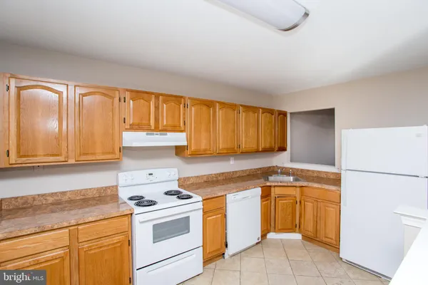 a kitchen with a stove top oven sink and cabinets
