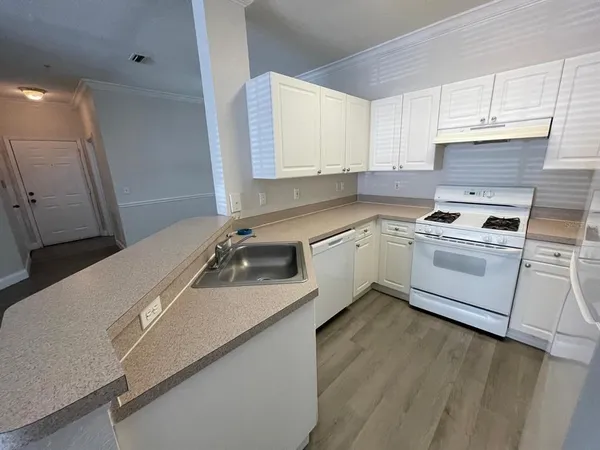 a kitchen with a sink stove and cabinets