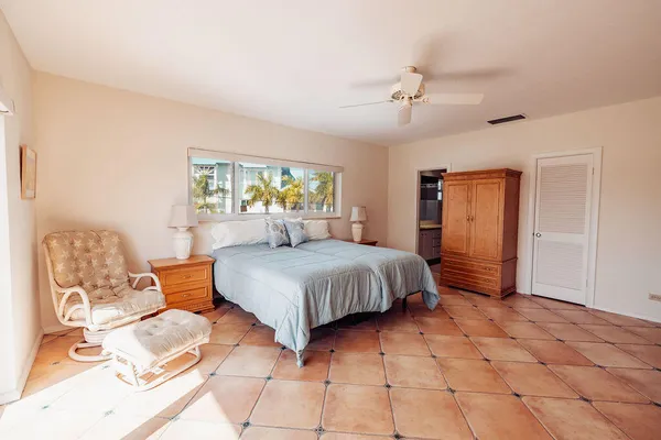 a spacious bedroom with a bed and a window