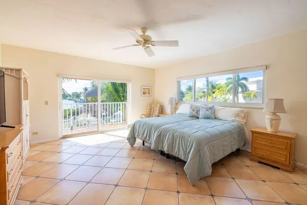 a bedroom with a bed and a flat tv screen