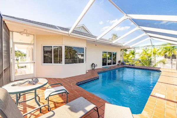 a dining room with wooden floor and large windows