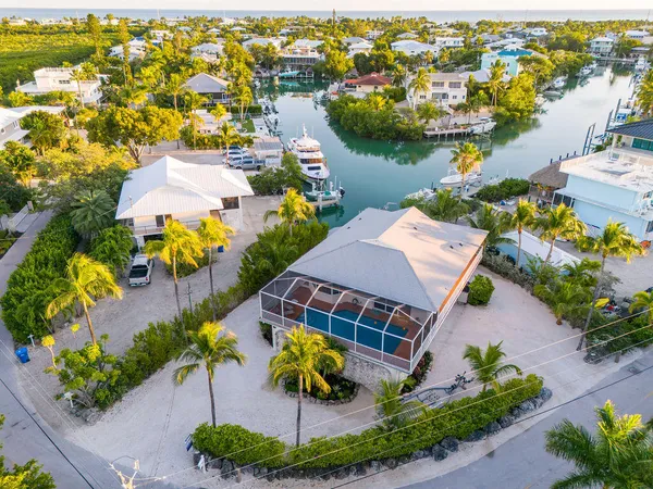 an aerial view of residential houses with outdoor space and swimming pool