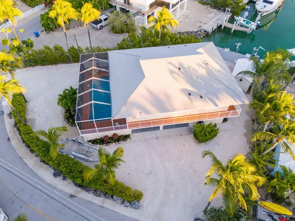 an aerial view of a house with a lake