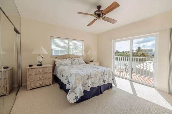 a spacious bedroom with a bed and a large window