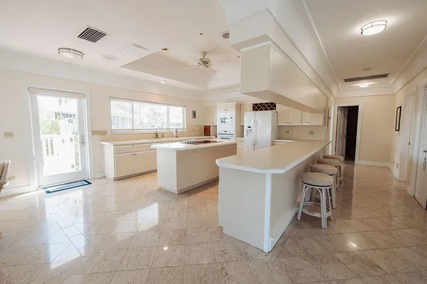 a kitchen with a cabinets and white appliances