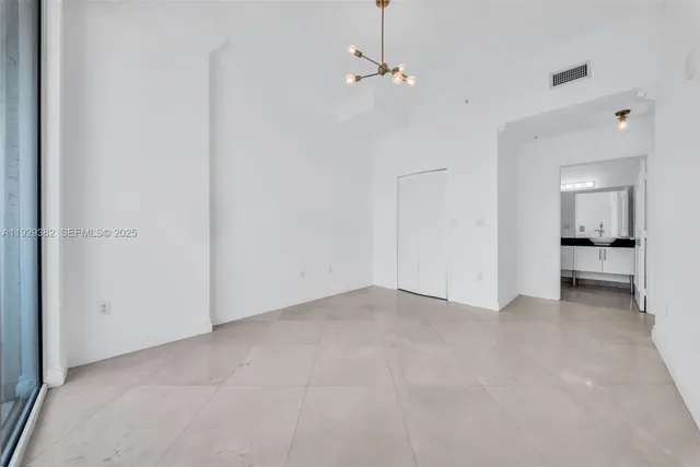 an empty room with a bathroom and a sink