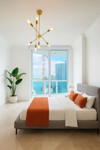 a bedroom with a bed and a potted plant