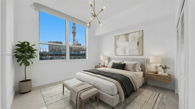 a bedroom with a bed and a potted plant