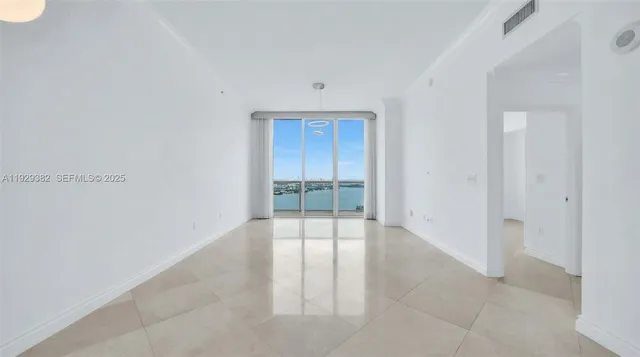 an empty room with sliding glass door