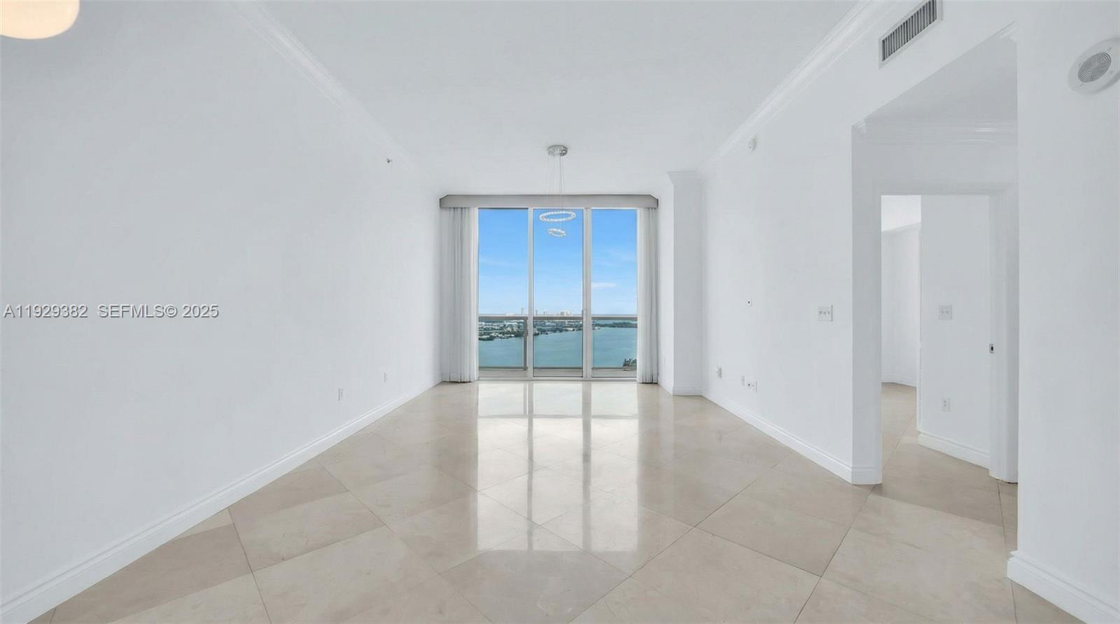 31 Southeast 5th Street, Unit 4314 Miami, FL 33131 - Photo 2 of 40 an empty room with sliding glass door