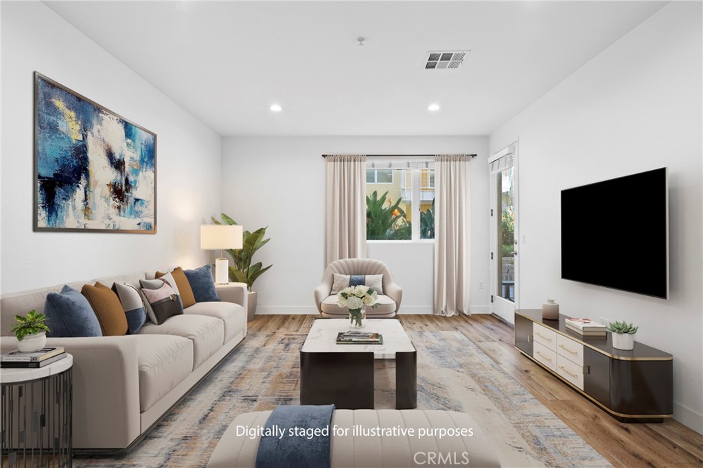 21301 Erwin Street, Unit 206 Woodland Hills, CA 91367 - Photo 1 of 34 a living room with furniture and a flat screen tv