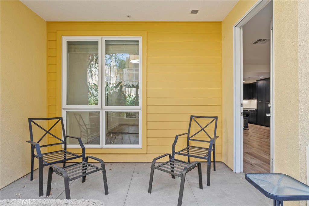 21301 Erwin Street, Unit 206 Woodland Hills, CA 91367 - Photo 17 of 34 a balcony with table and chairs
