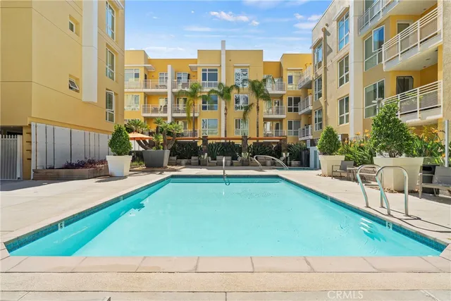 a swimming pool with outdoor seating and yard