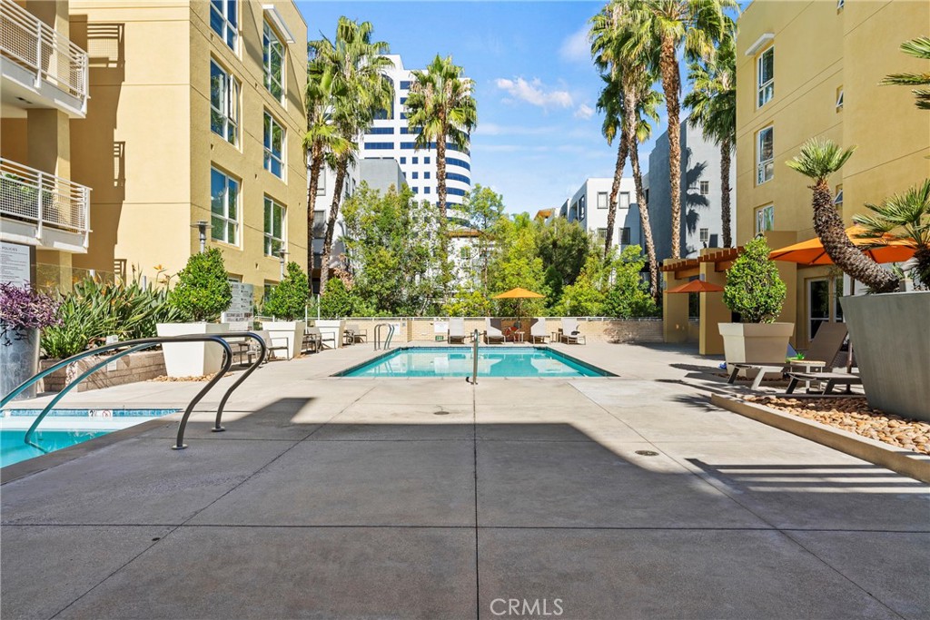 21301 Erwin Street, Unit 206 Woodland Hills, CA 91367 - Photo 20 of 34 a swimming pool with outdoor seating and yard